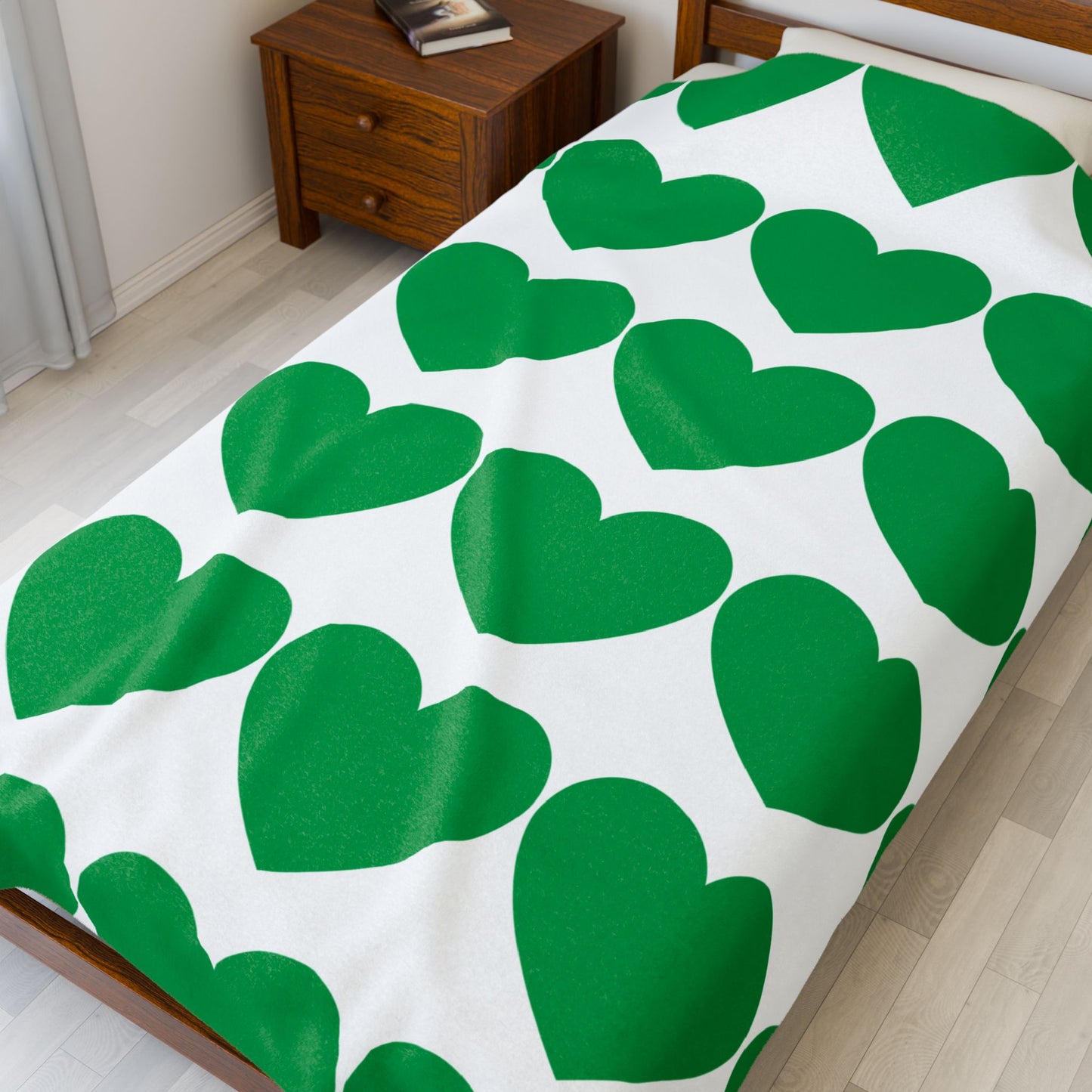 Close-up of plush texture and green heart motif on cozy throw