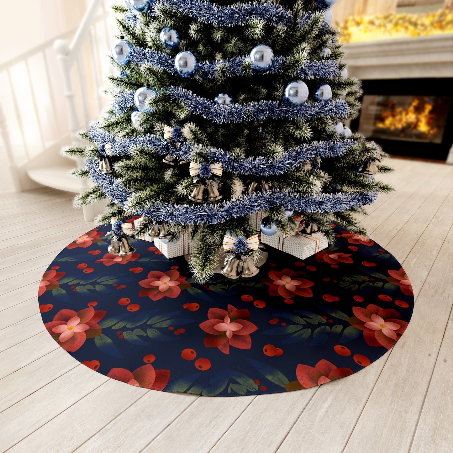 Elegant dark blue Christmas tree skirt with silver poinsettia design styled under a decorated fir tree near twinkling lights and wrapped gifts in a festive living room