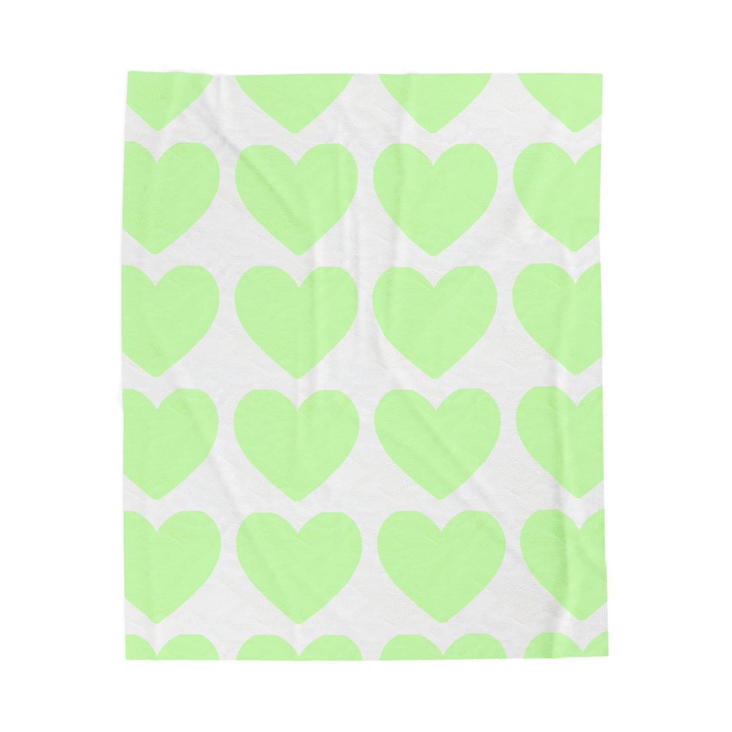 Folded mint green blanket with heart print for self-care dorm vibes