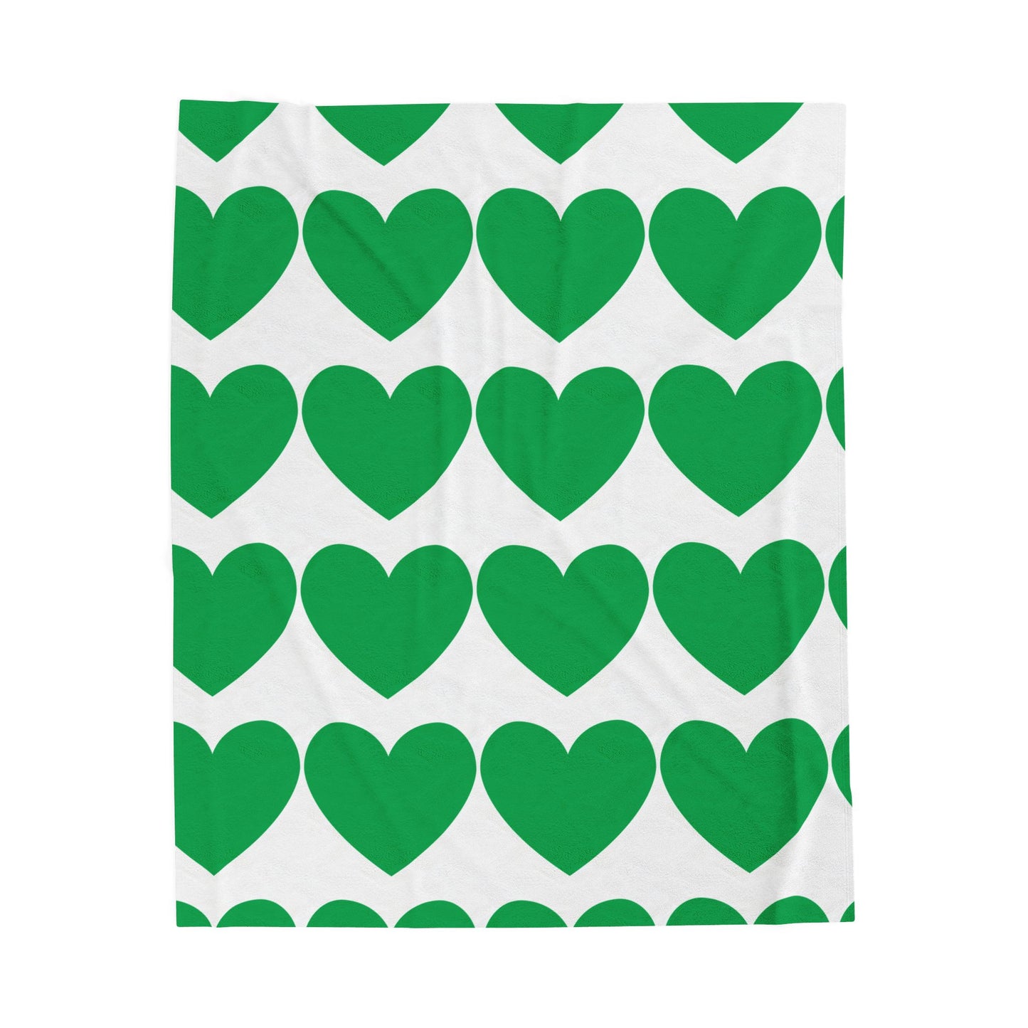 Green hearts plush throw blanket styled on a cozy dorm bed