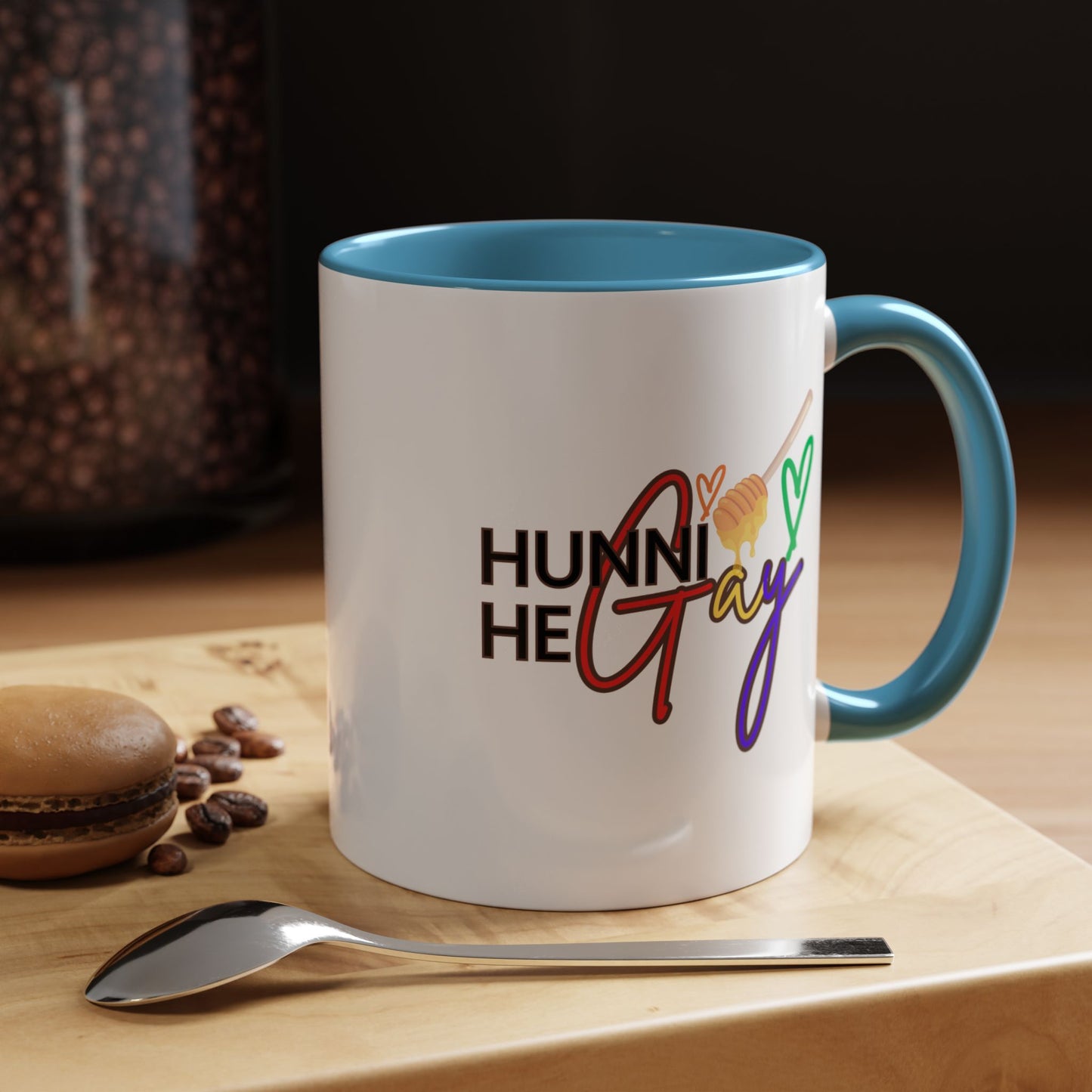 Eye-catching LGBTQ+ coffee cup with colorful "Hunni He Gay" typography, finished with a delicate baby blue accent that adds a stylish Pride touch.