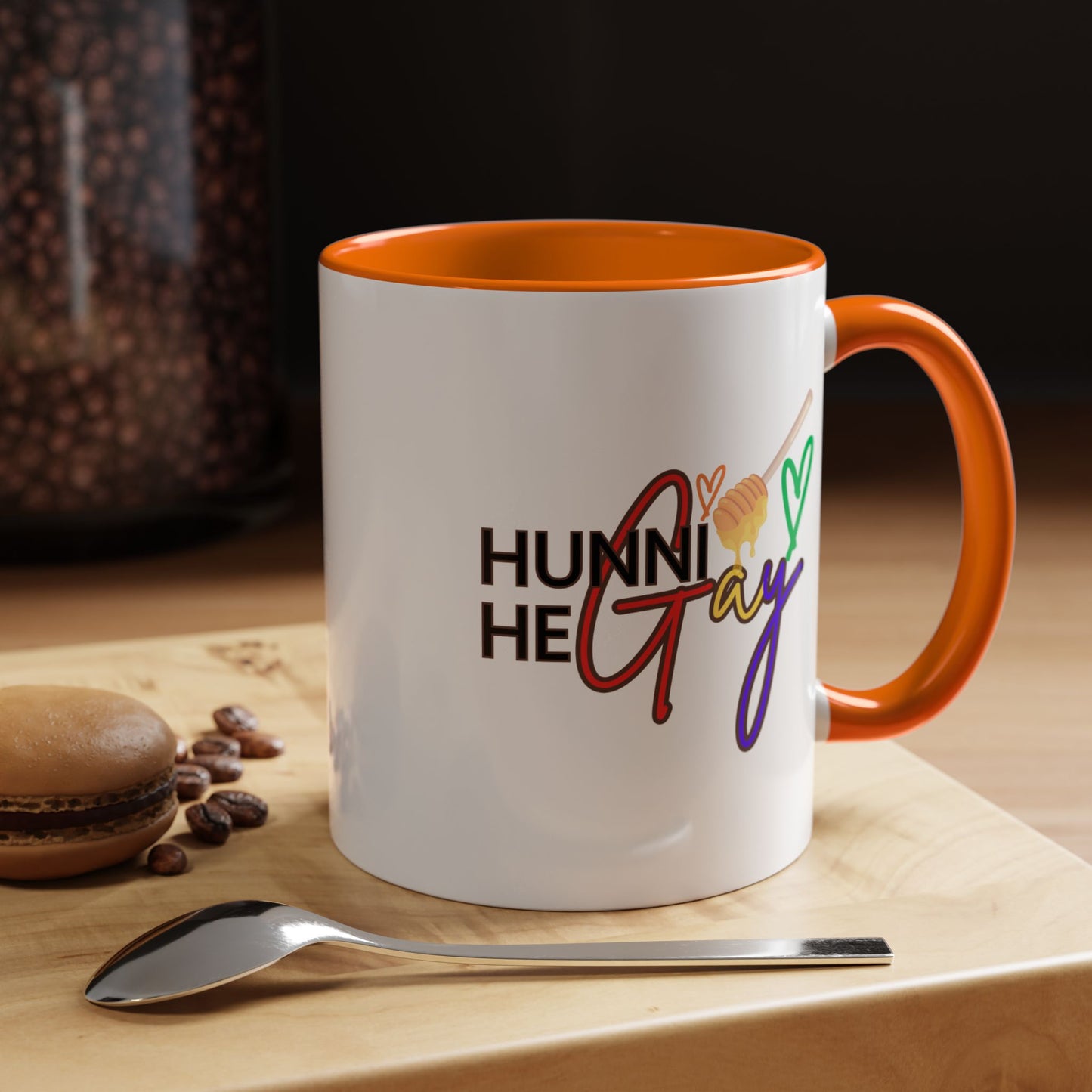 Bold and vibrant "Hunni He Gay" ceramic coffee mug with a bright orange handle and rim, designed to add a fiery burst of Pride to your daily routine.