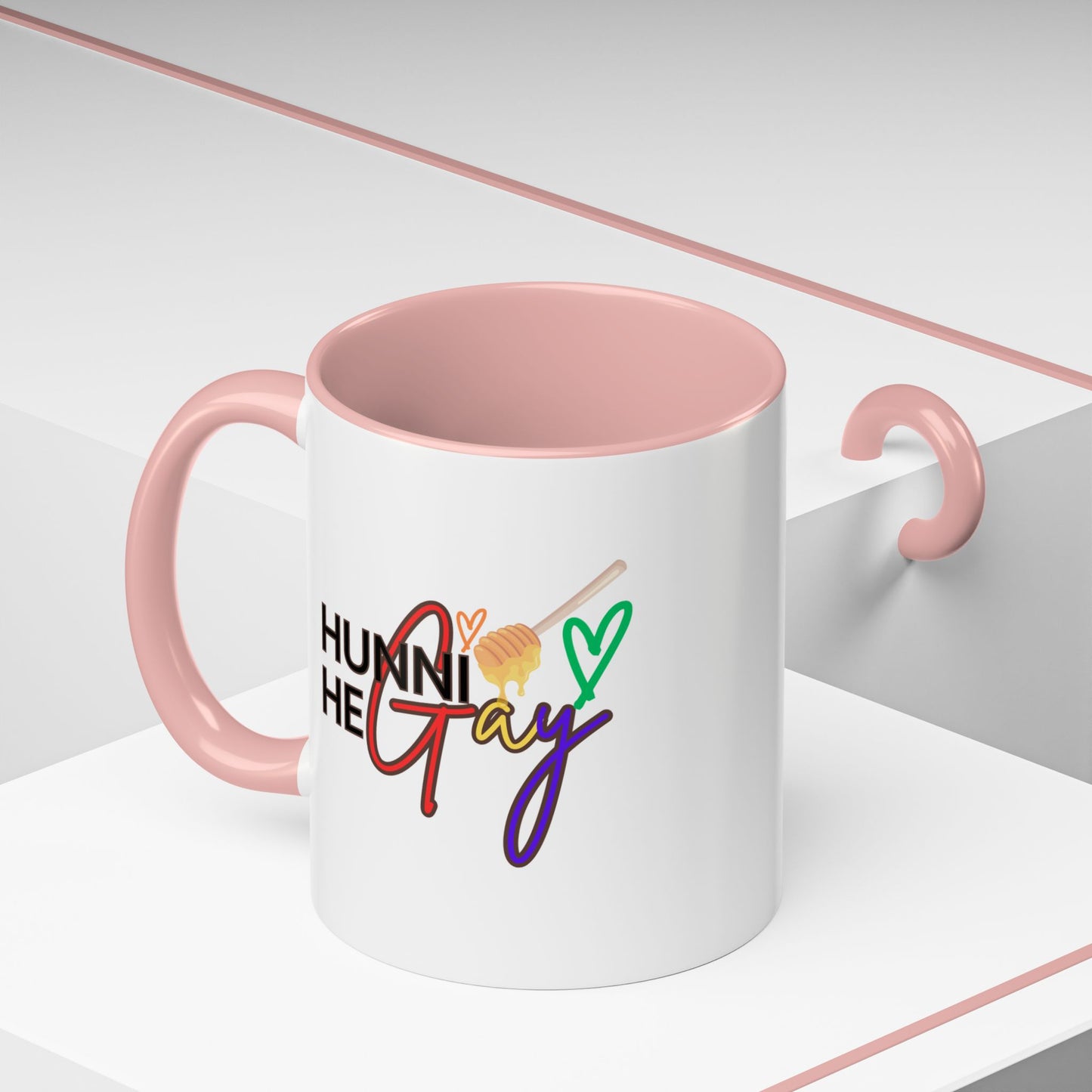 Bright and sassy Pride mug with "Hunni He Gay" printed in retro rainbow font, complemented by a soft bubblegum pink interior and handle for a fun, colorful statement.