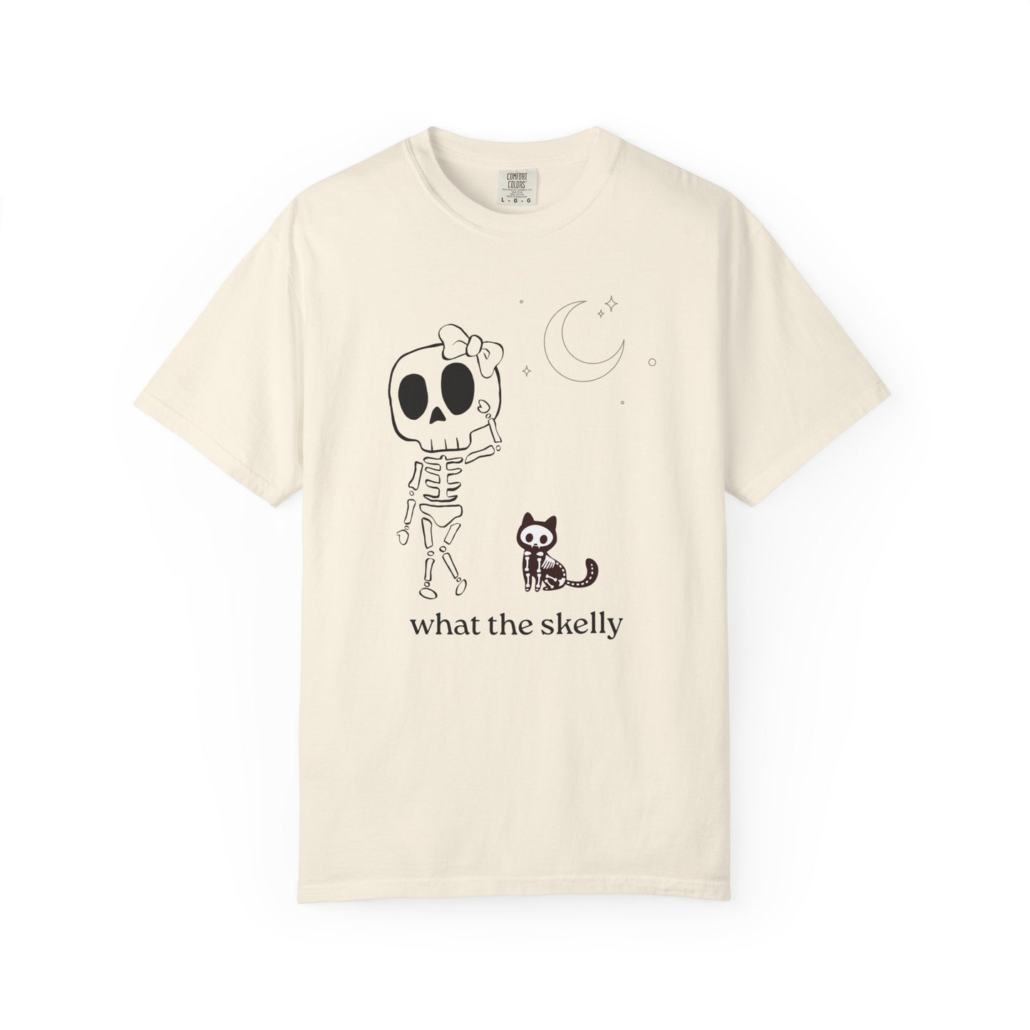 Ivory tee with “What the Skelly?” skeleton and cat design, styled for cozy fall fashion and Halloween charm.
