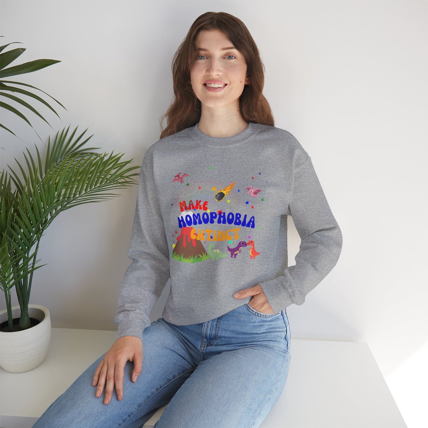 Soft light gray crewneck sweatshirt featuring playful dinosaurs and “Make Homophobia Extinct” text—cozy, bold, and full of LGBTQ+ pride.