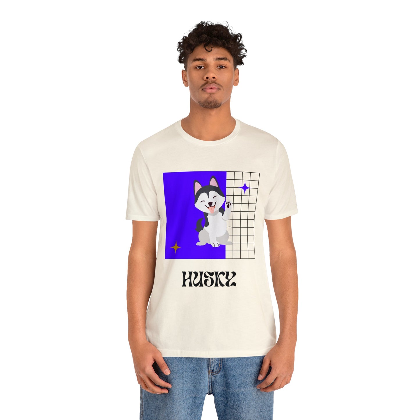 Woman at tailgate party wearing soft cream husky-inspired t-shirt with purple and gold design, holding a drink and laughing with friends.
