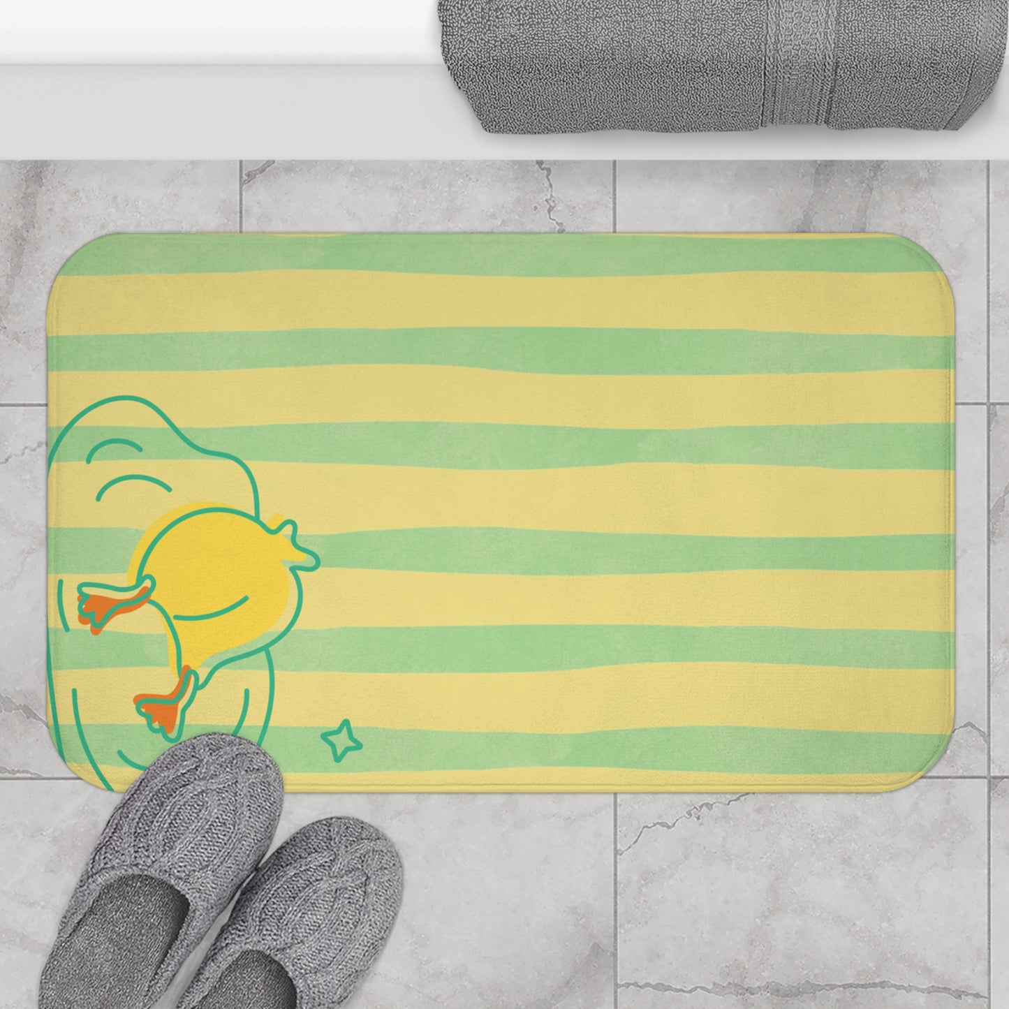 Folded duck-themed bath mat with yellow and green stripes for quirky decor