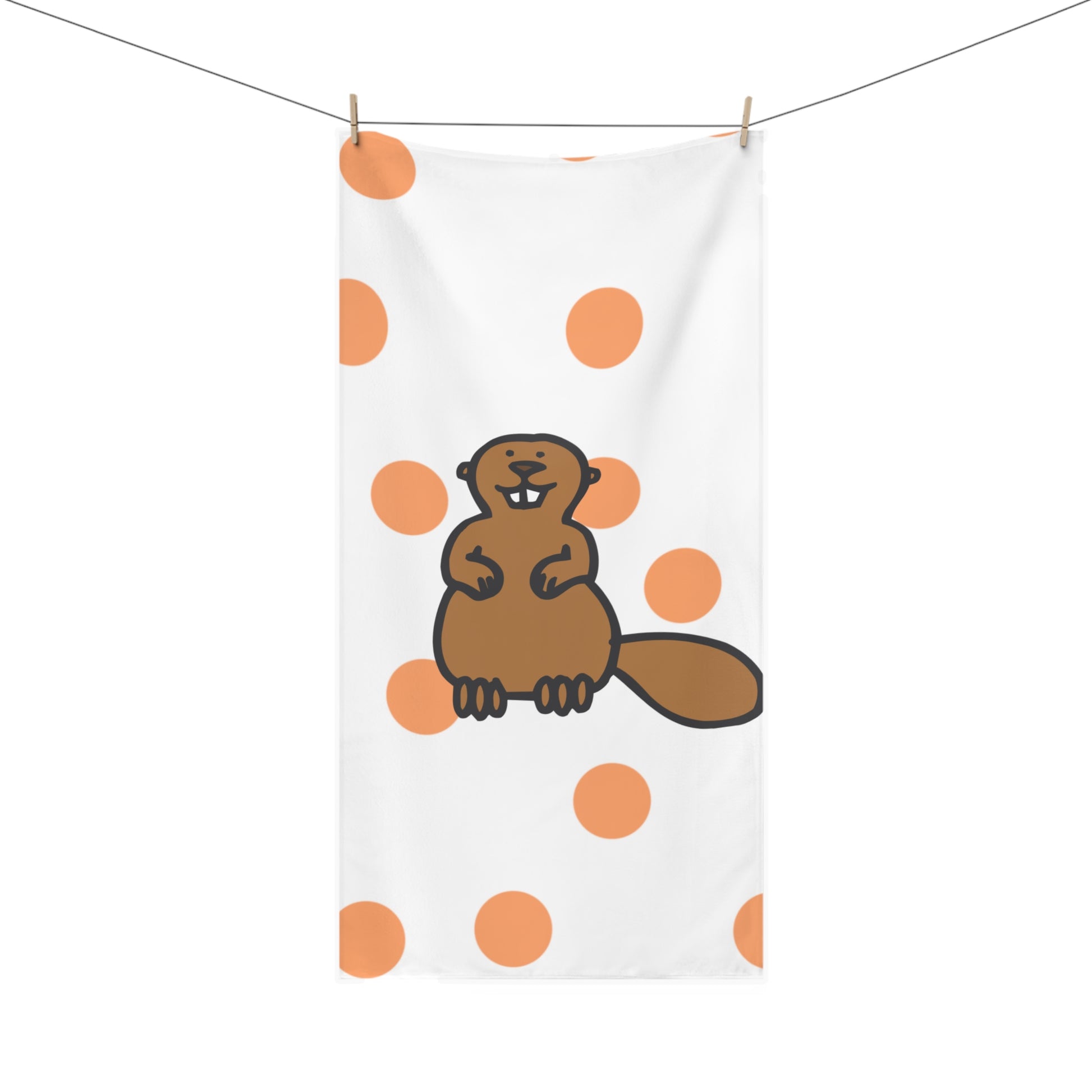 Close-up of beaver-inspired pattern on orange polka dot towel