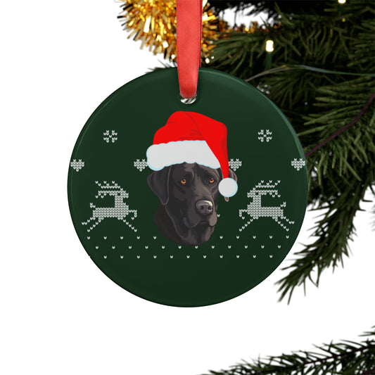 black lab ornament wearing Santa hat hanging on Christmas tree with twinkling lights and pine branches