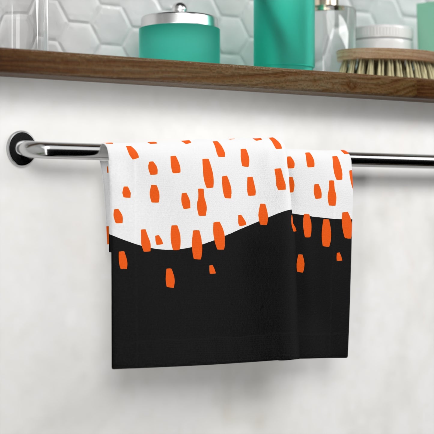 Close-up of microfiber texture and orange droplet design on black towe