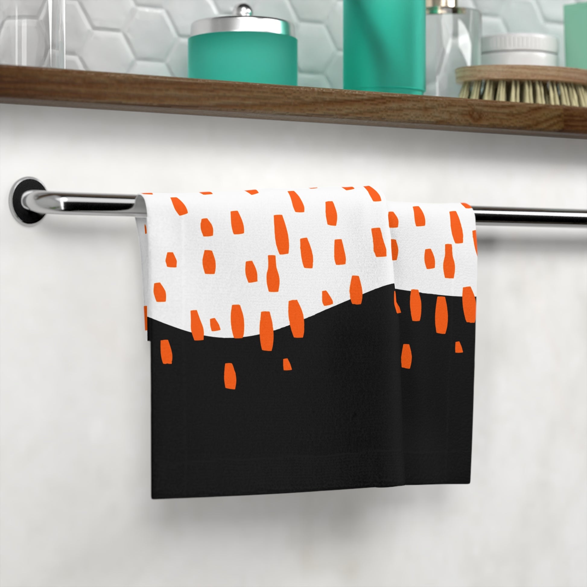 Close-up of microfiber texture and orange droplet design on black towe