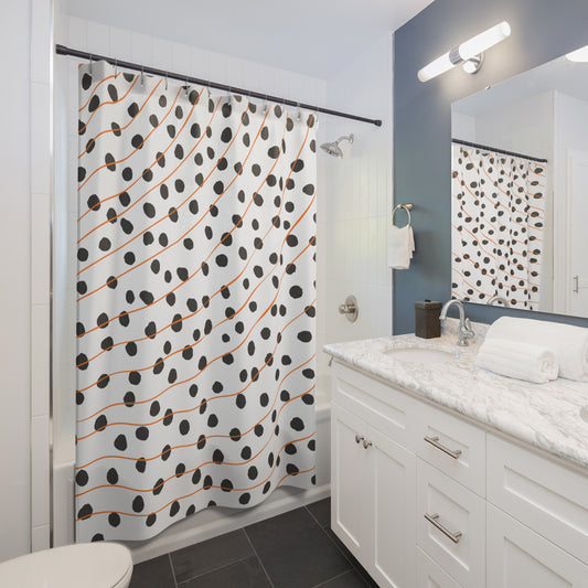 Front view of modern orange shower curtain with polka dots and abstract stripes
