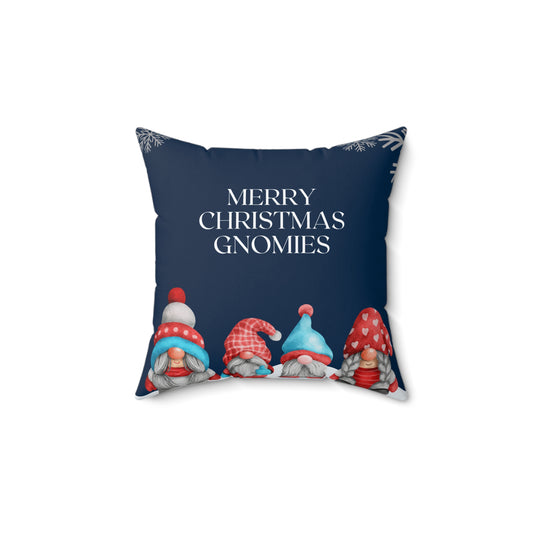 Flat lay of blue holiday throw pillow featuring whimsical gnome trio and white festive lettering on soft fabric