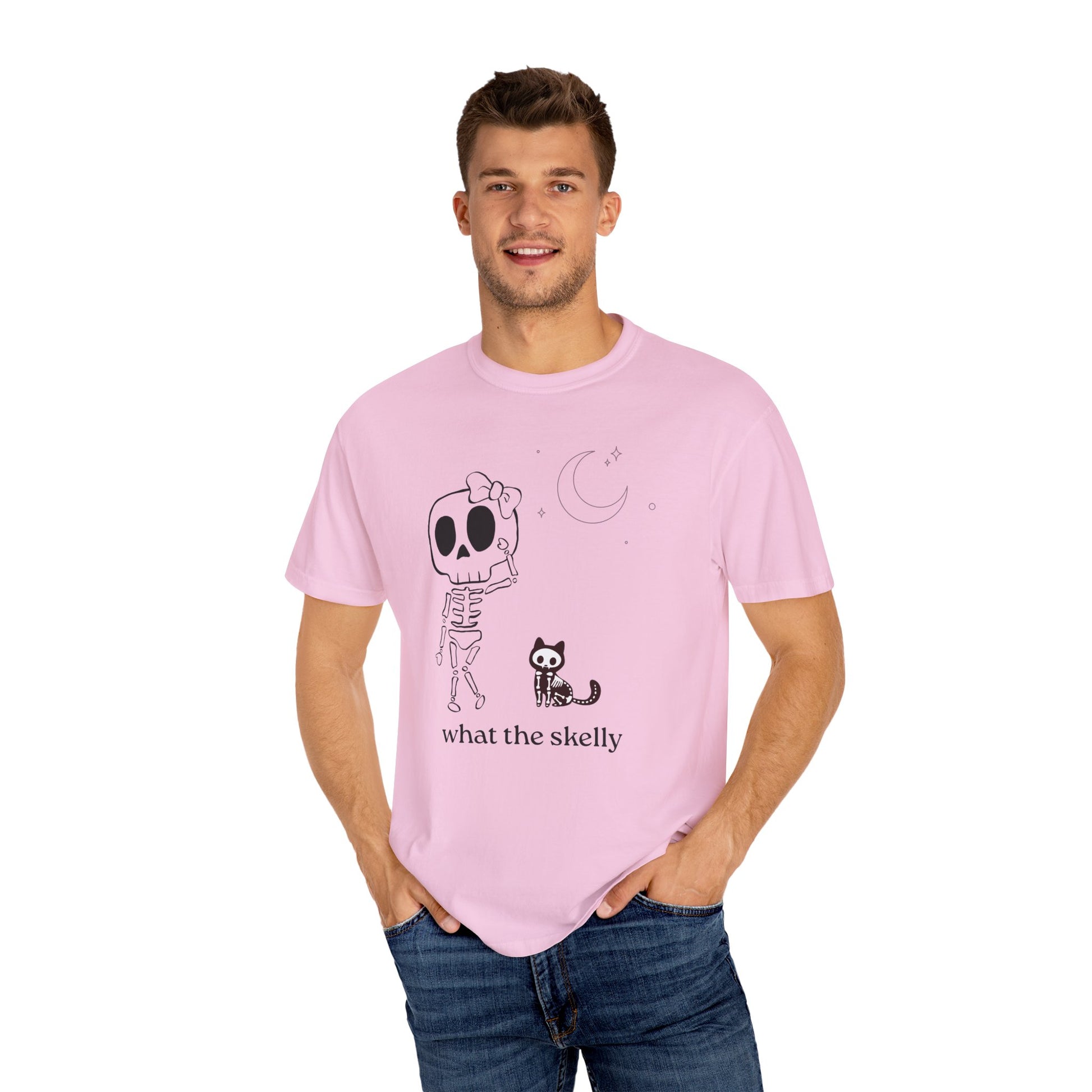 Pink Halloween tee with boho skeleton and cat graphic, featuring “What the Skelly?” message for playful spooky season style.