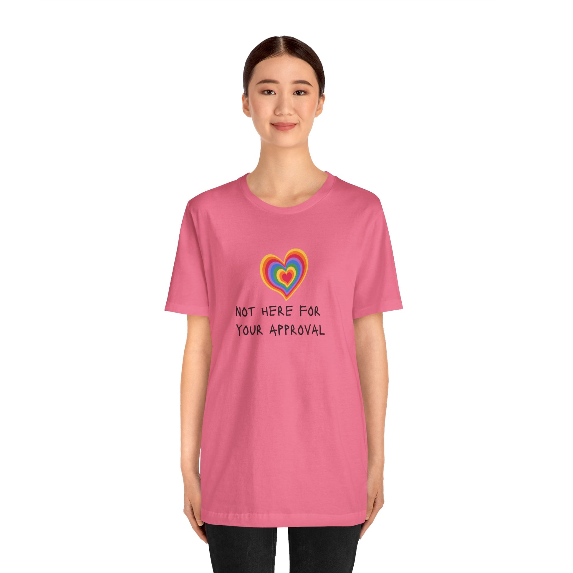 - Striking bright pink Pride T-shirt showcasing colorful “Not Here for Your Approval” lettering and a rainbow heart—playful, unapologetic, and perfect for Pride celebrations.
