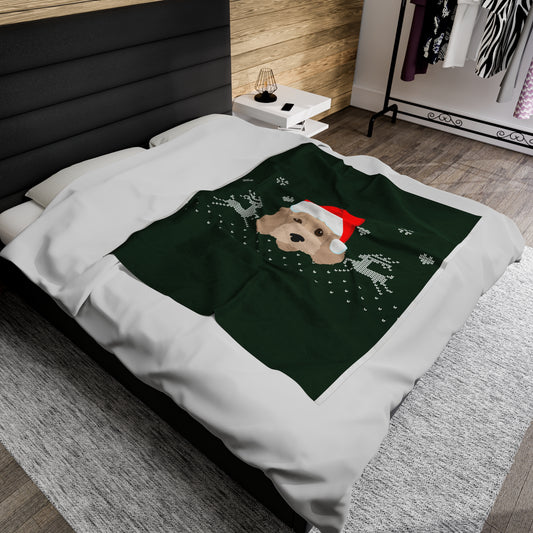Festive Christmas blanket featuring Cockapoo in Santa hat draped over holiday sofa with twinkle lights, pillows, and cozy decor