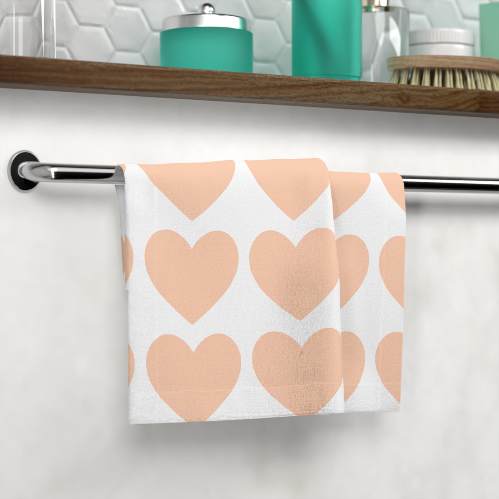 Orange hearts towel styled on bathroom counter with skincare products