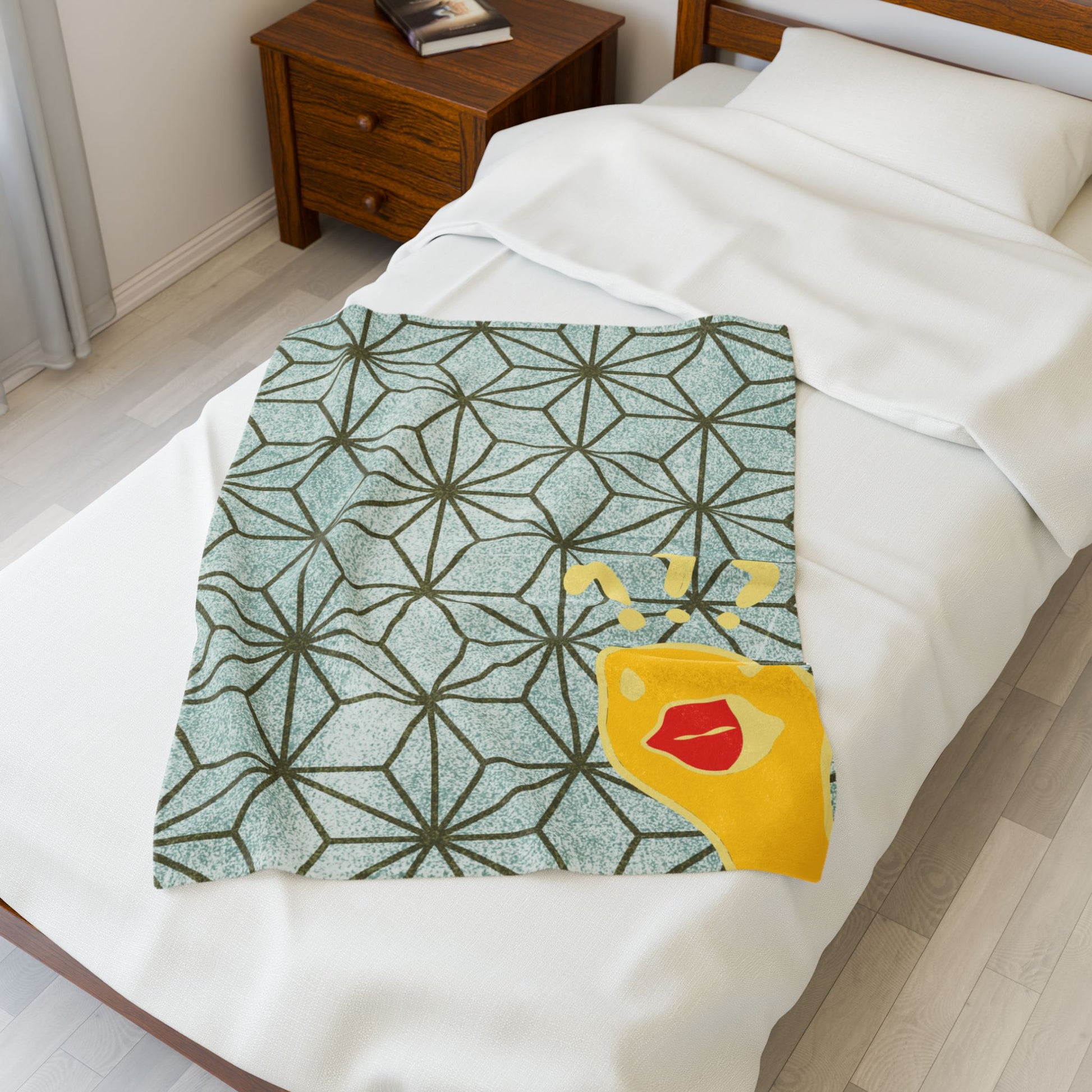 Folded plush blanket with “What the Duck” attitude, green and gold design for edgy home style