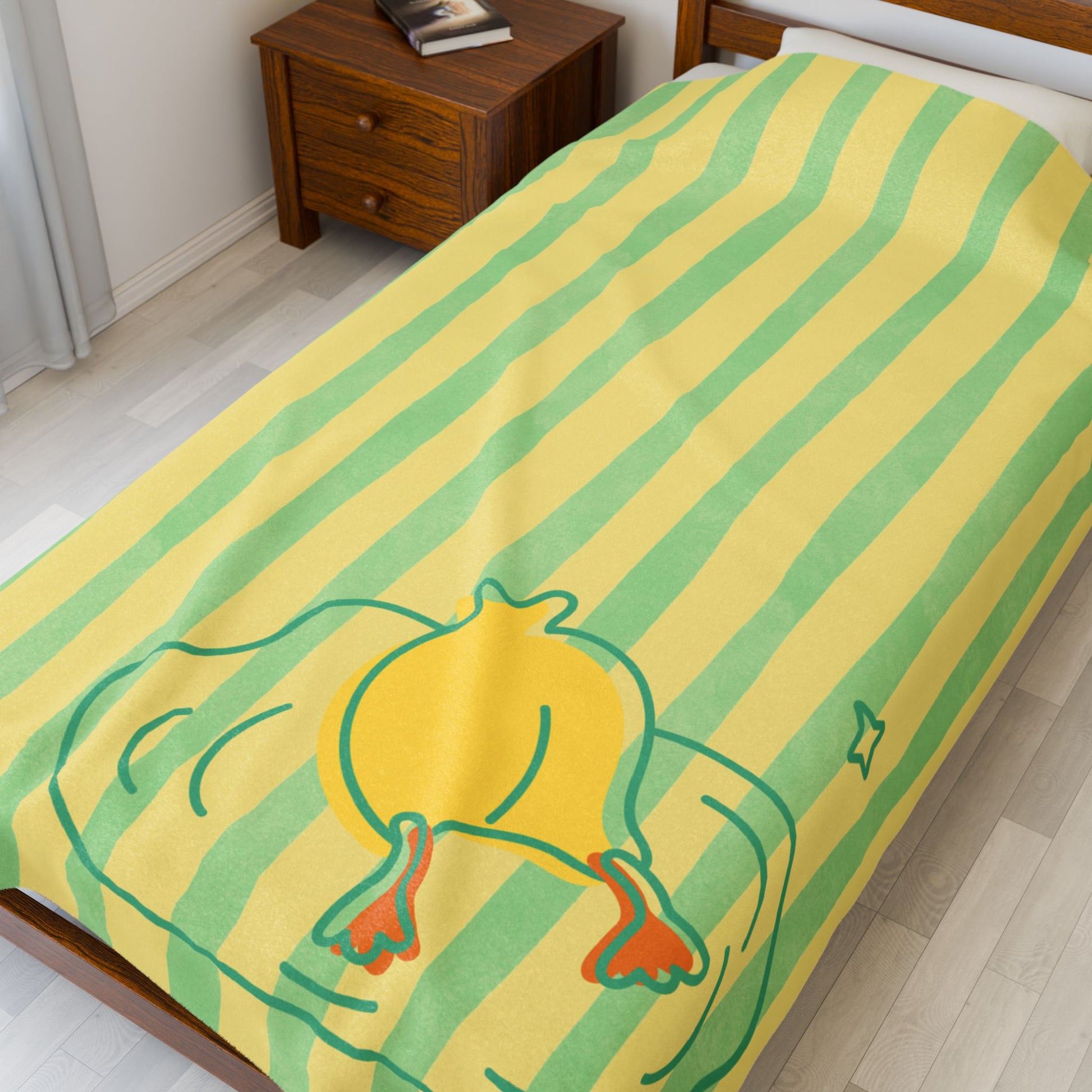 Close-up of soft plush texture and duck-themed pattern with yellow and green stripes