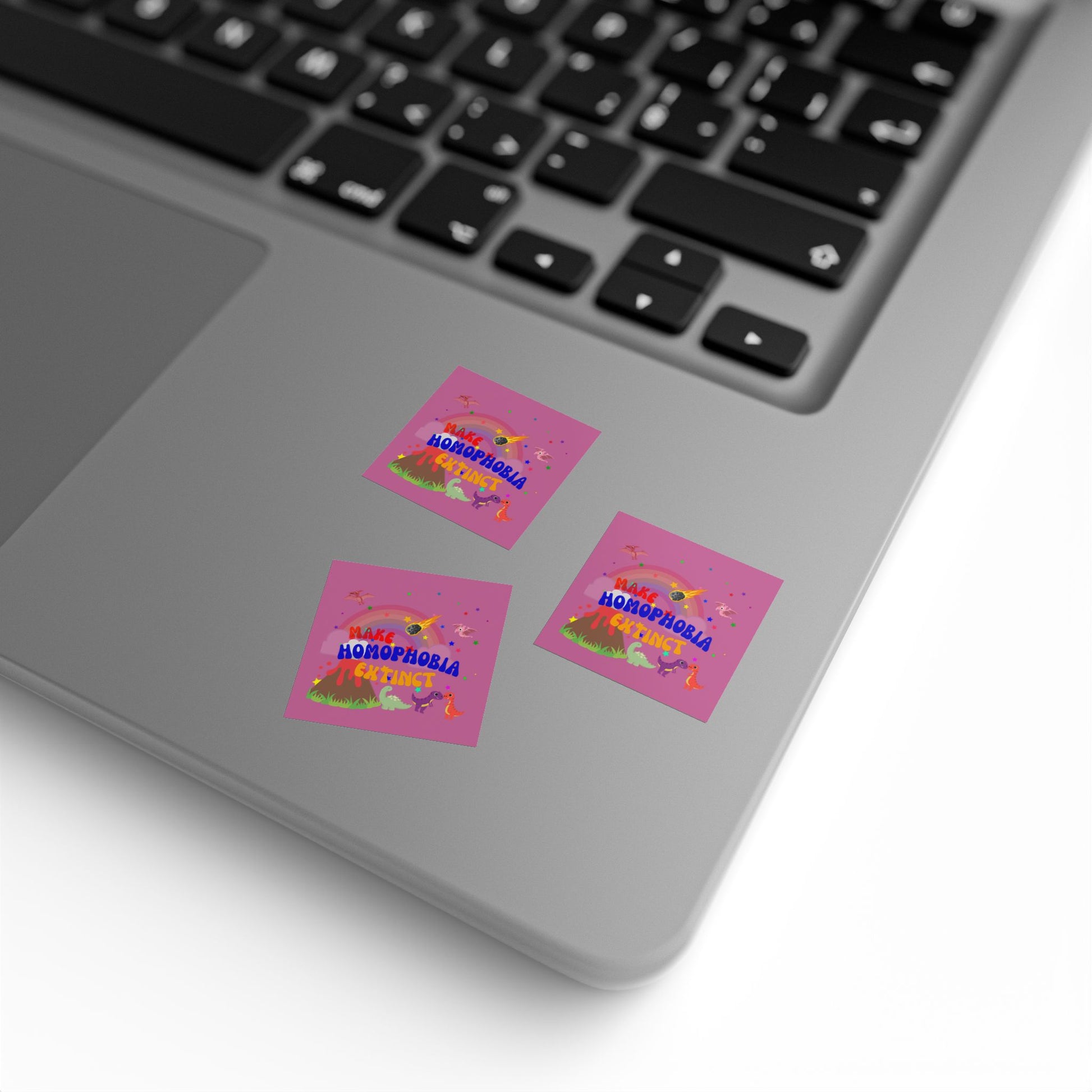 Soft pink sticker featuring a roaring dinosaur and “Make Homophobia Extinct” phrase—bold, expressive, and full of Pride energy.