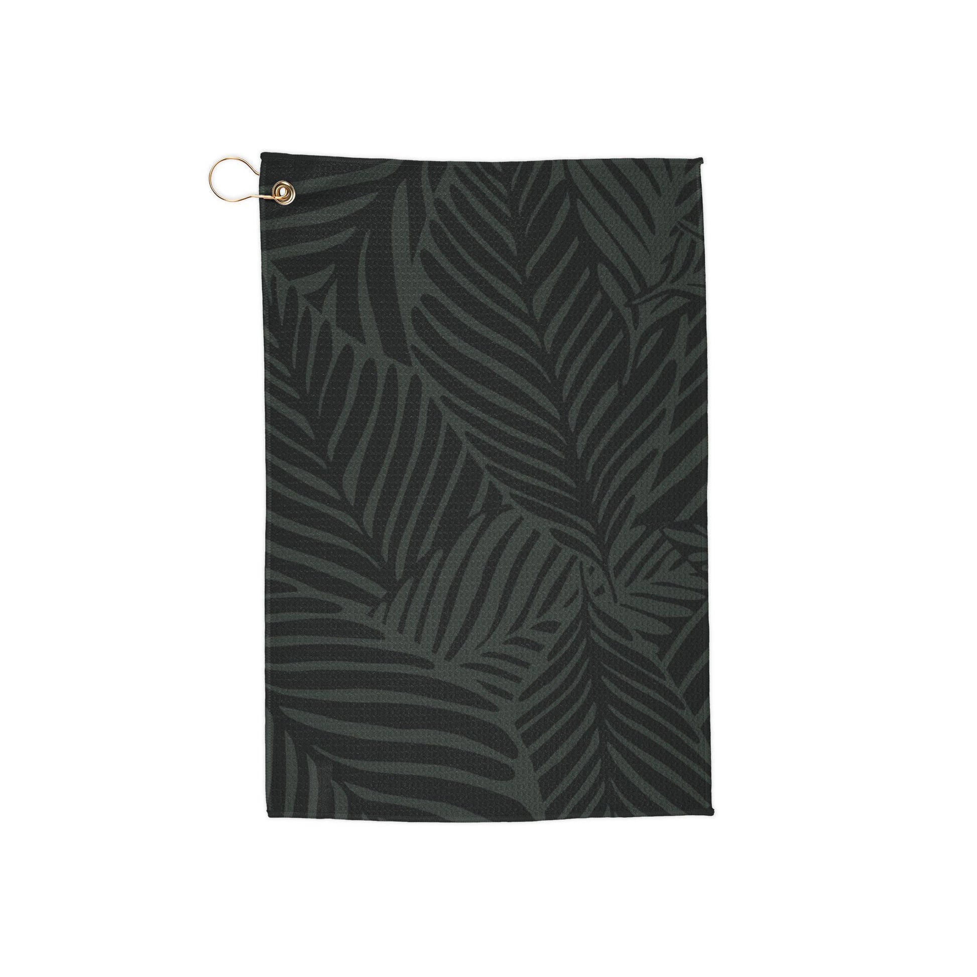 A moody, rich-toned golf towel covered in deep green jungle leaves for an earthy, tropical aesthetic. Stylish and effortlessly cool.