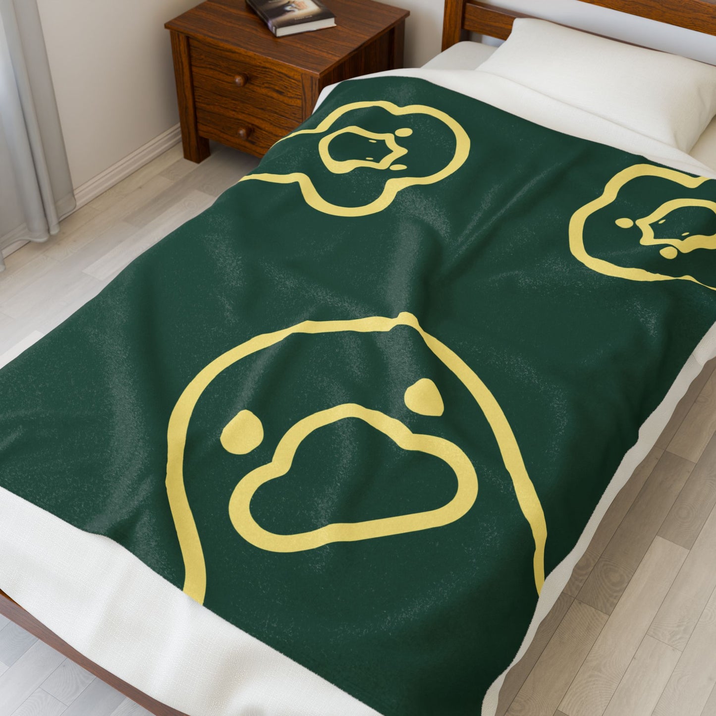 Dark green college-style blanket styled on dorm bed with cozy decor