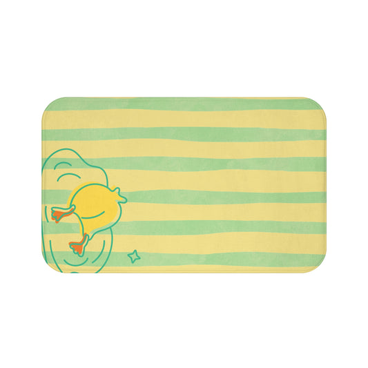 Yellow and green striped bath mat with duck “buns up” design styled in college dorm bathroom