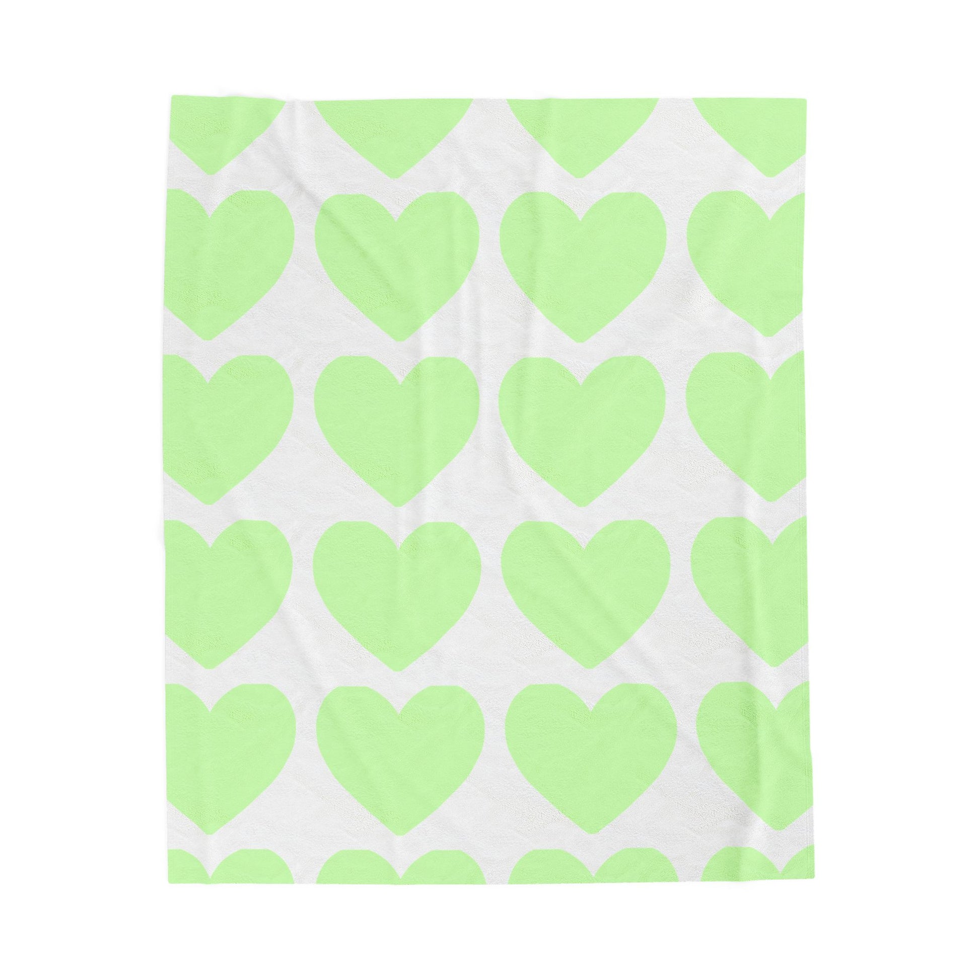 Folded mint green blanket with heart print for self-care dorm vibes