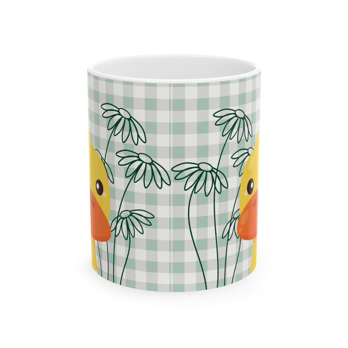 Closeup of ceramic coffee mug with green gingham pattern, daisy flowers, and duck illustration, perfect for college kitchen decor