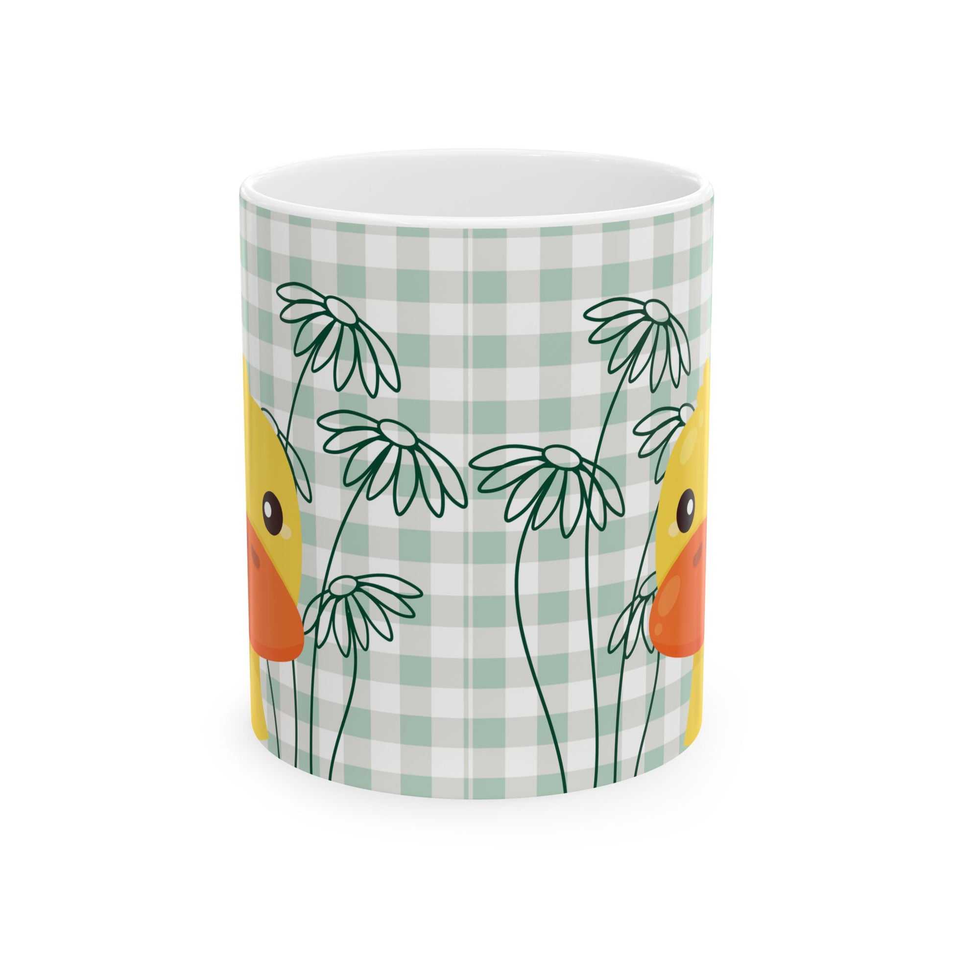 Closeup of ceramic coffee mug with green gingham pattern, daisy flowers, and duck illustration, perfect for college kitchen decor