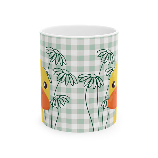 Closeup of ceramic coffee mug with green gingham pattern, daisy flowers, and duck illustration, perfect for college kitchen decor