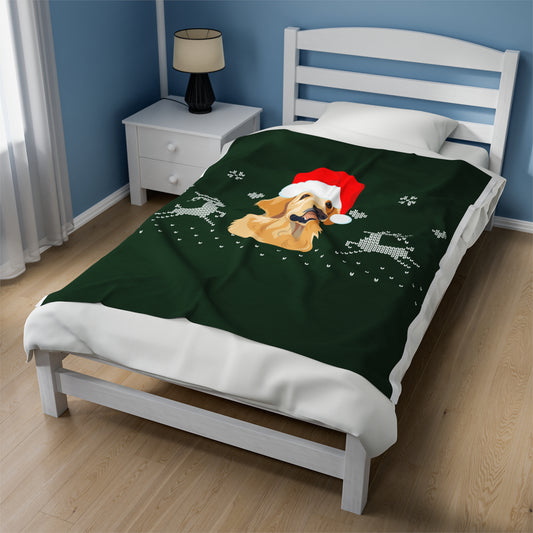 Green holiday blanket featuring golden retriever in Santa hat draped over festive couch with cozy pillows, twinkle lights, and seasonal decor