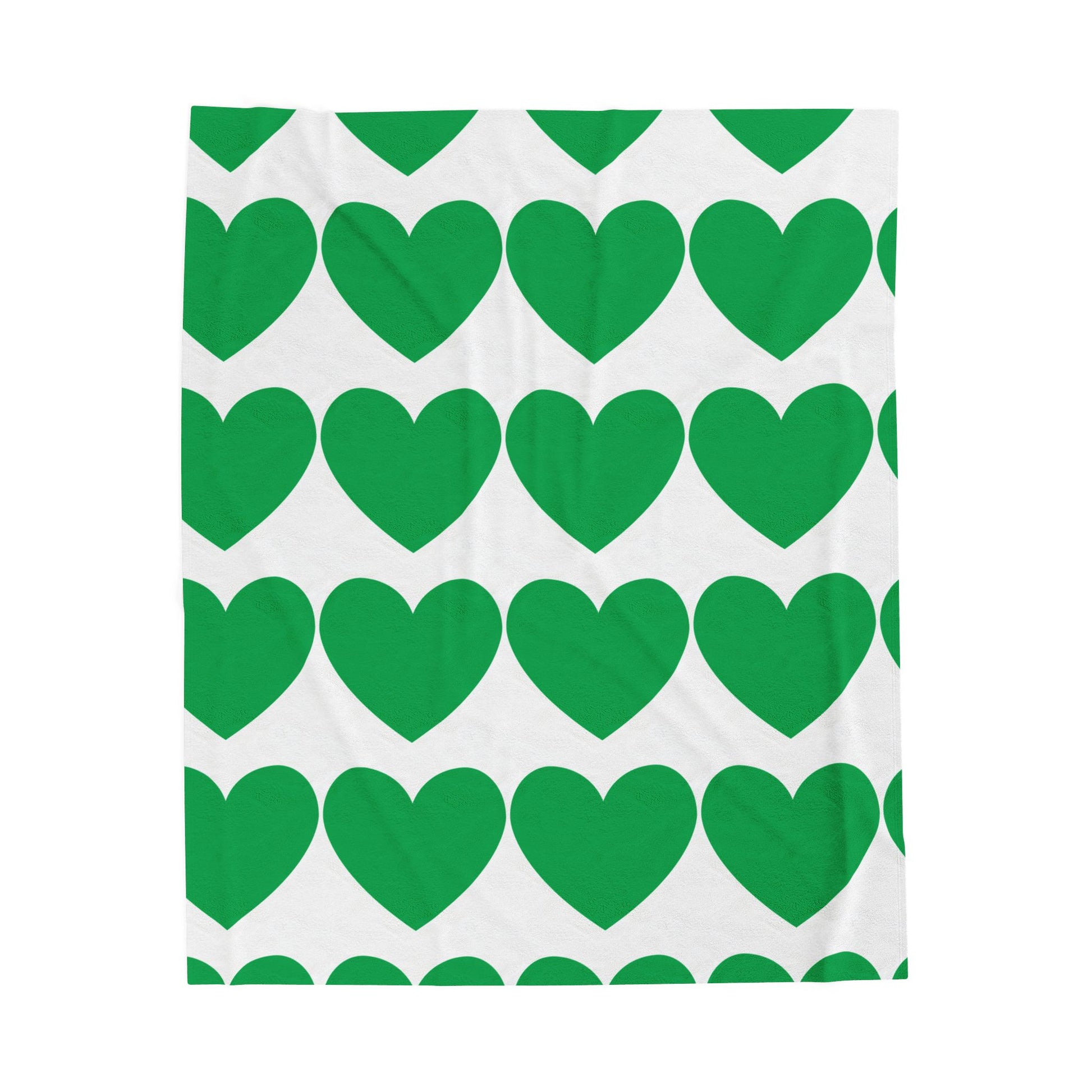 Green hearts plush throw blanket styled on a cozy dorm bed