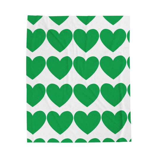 Green hearts plush throw blanket styled on a cozy dorm bed
