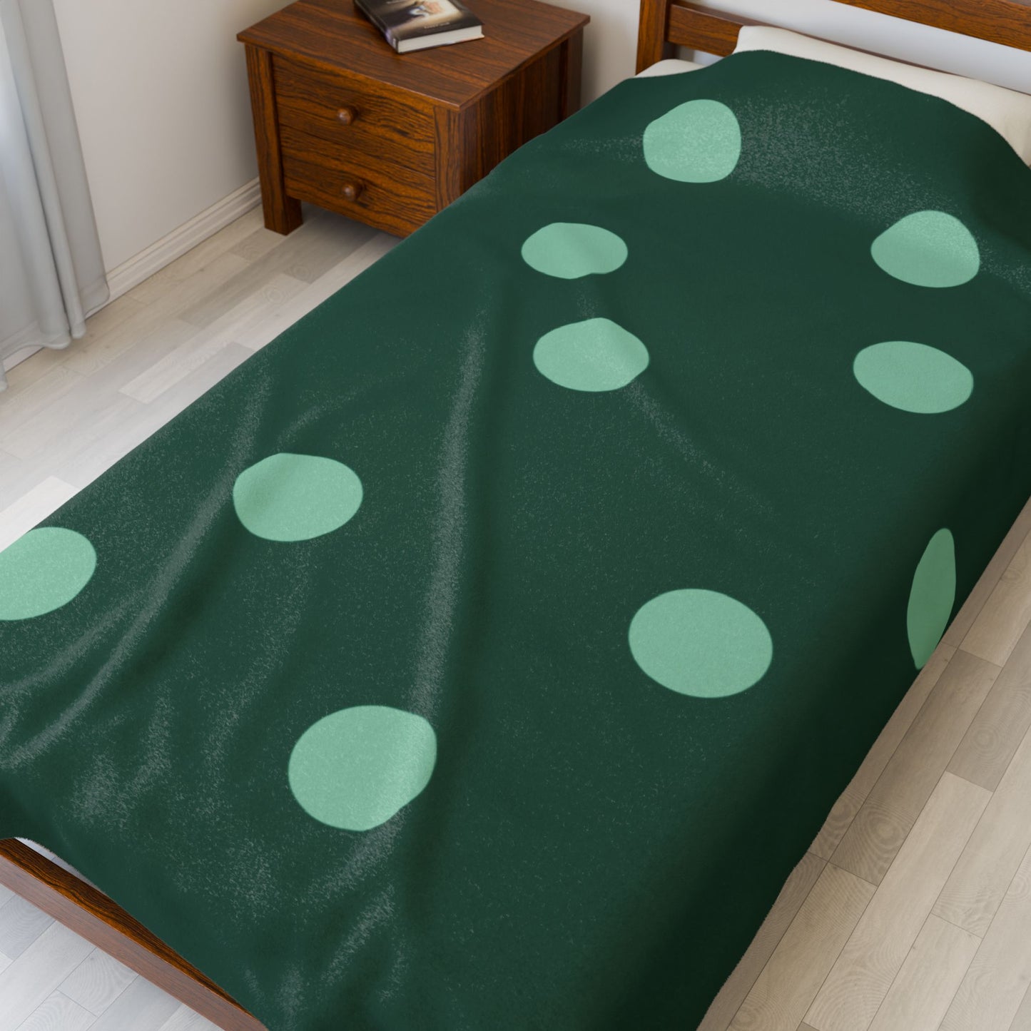 Close-up of soft plush texture and alternating green dot design