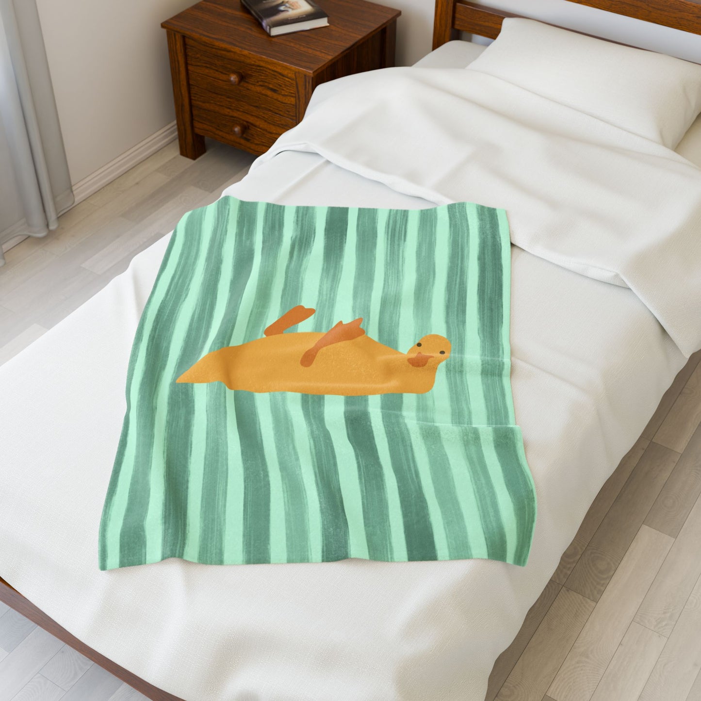 Striped green plush blanket styled on dorm bed with moody, cozy accessories