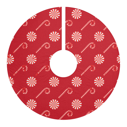 Red candy cane Christmas tree skirt under decorated holiday tree
