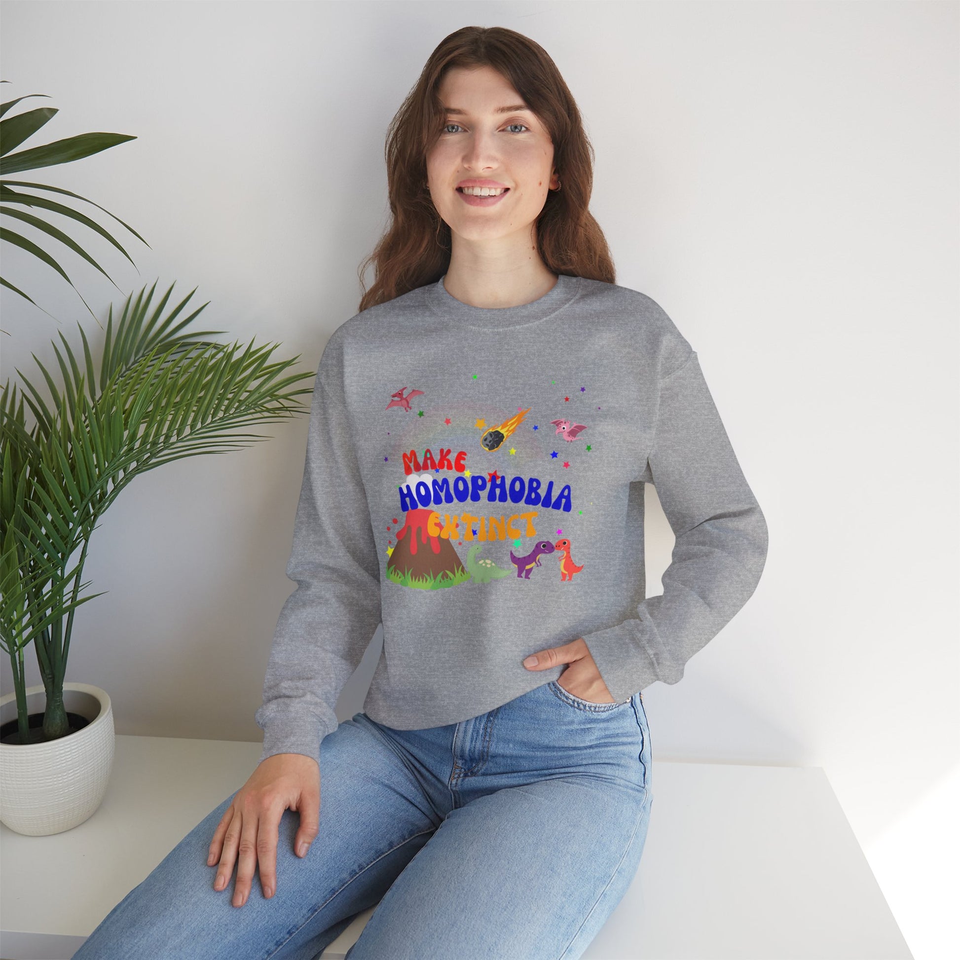 Soft light gray crewneck sweatshirt featuring playful dinosaurs and “Make Homophobia Extinct” text—cozy, bold, and full of LGBTQ+ pride.