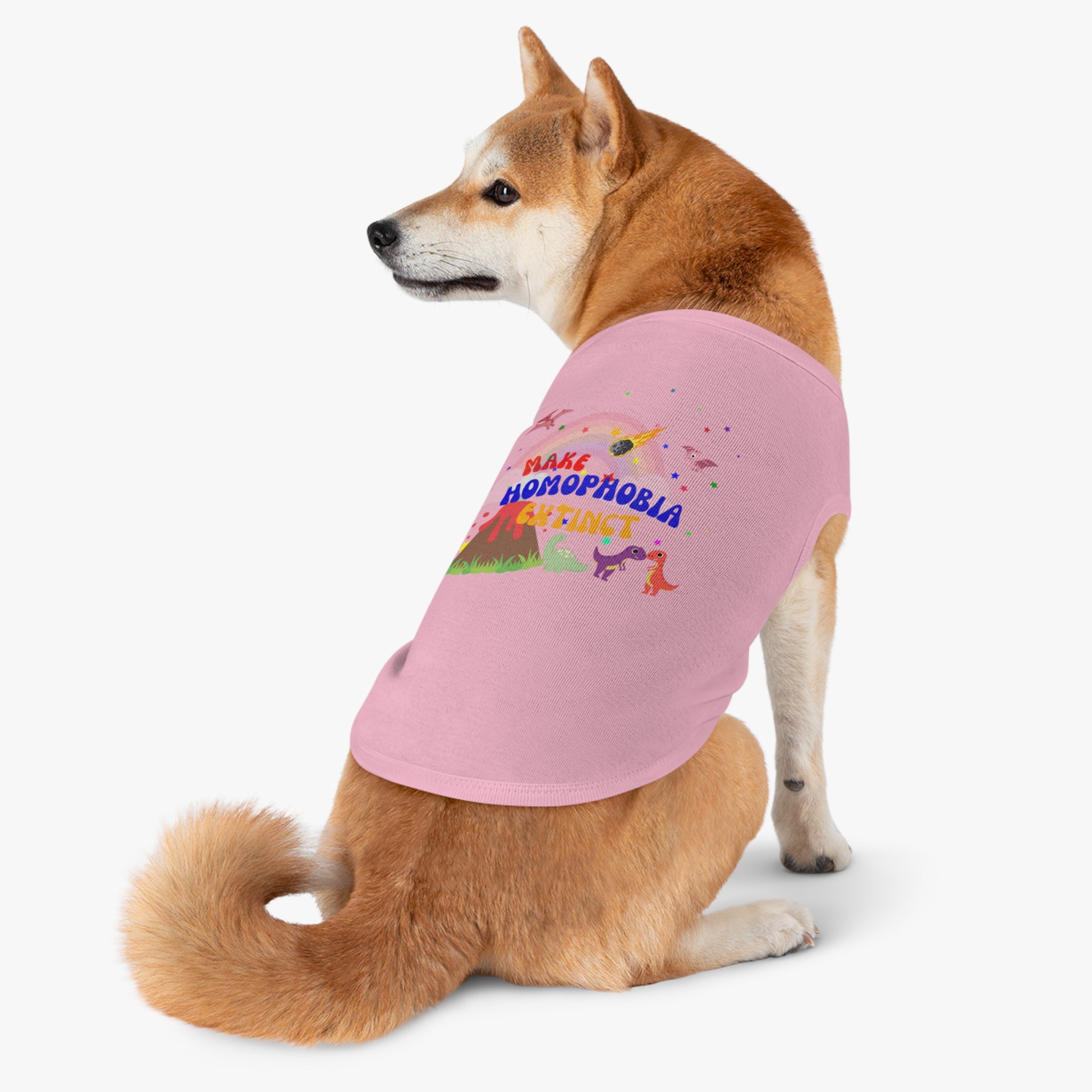 Soft pink LGBTQ+ t-shirt with a charming dinosaur and a dog, perfect for spreading love and inclusivity.featuring “Make Homophobia Extinct”