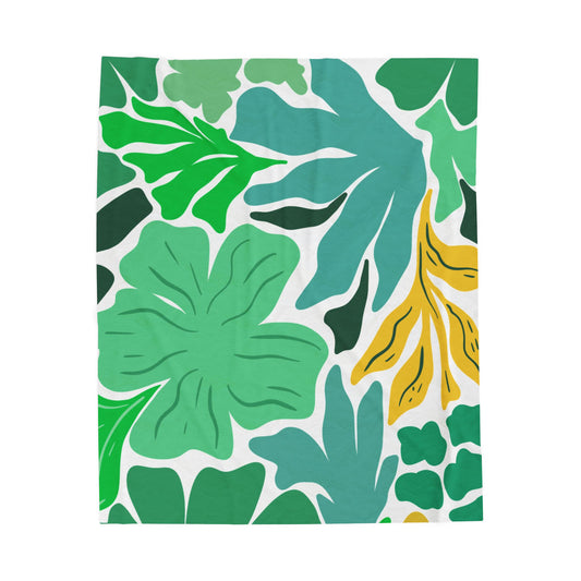Bold green and yellow floral plush blanket styled on maximalist bedding with dopamine decor accents