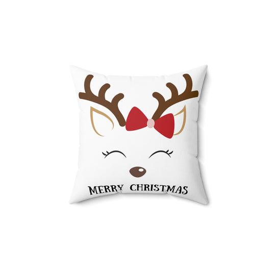 Flat lay of white throw pillow featuring adorable reindeer illustration and festive script on soft textured fabric