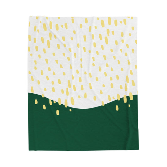 Midcentury-style plush blanket with green and yellow abstract rain pattern on retro-styled bedding