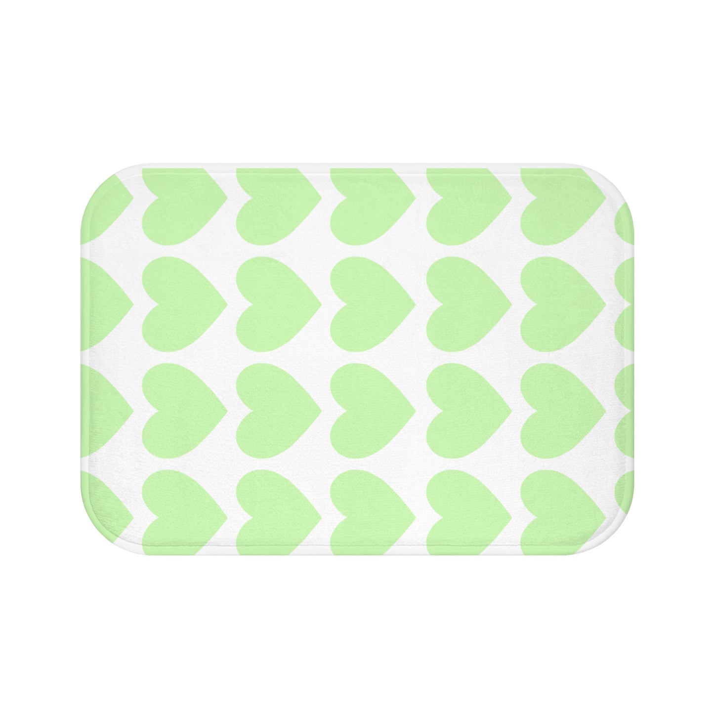 Plush bath mat with mint green hearts design styled in college dorm bathroom