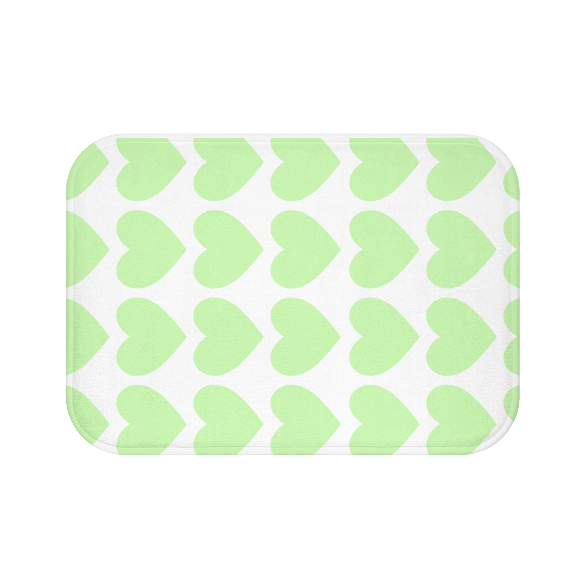 Plush bath mat with mint green hearts design styled in college dorm bathroom