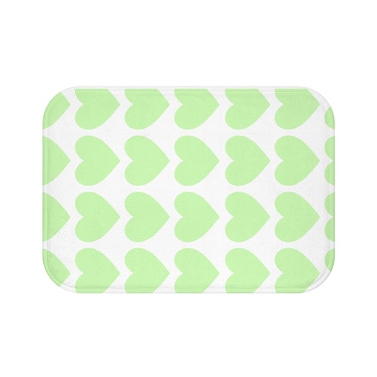 Plush bath mat with mint green hearts design styled in college dorm bathroom