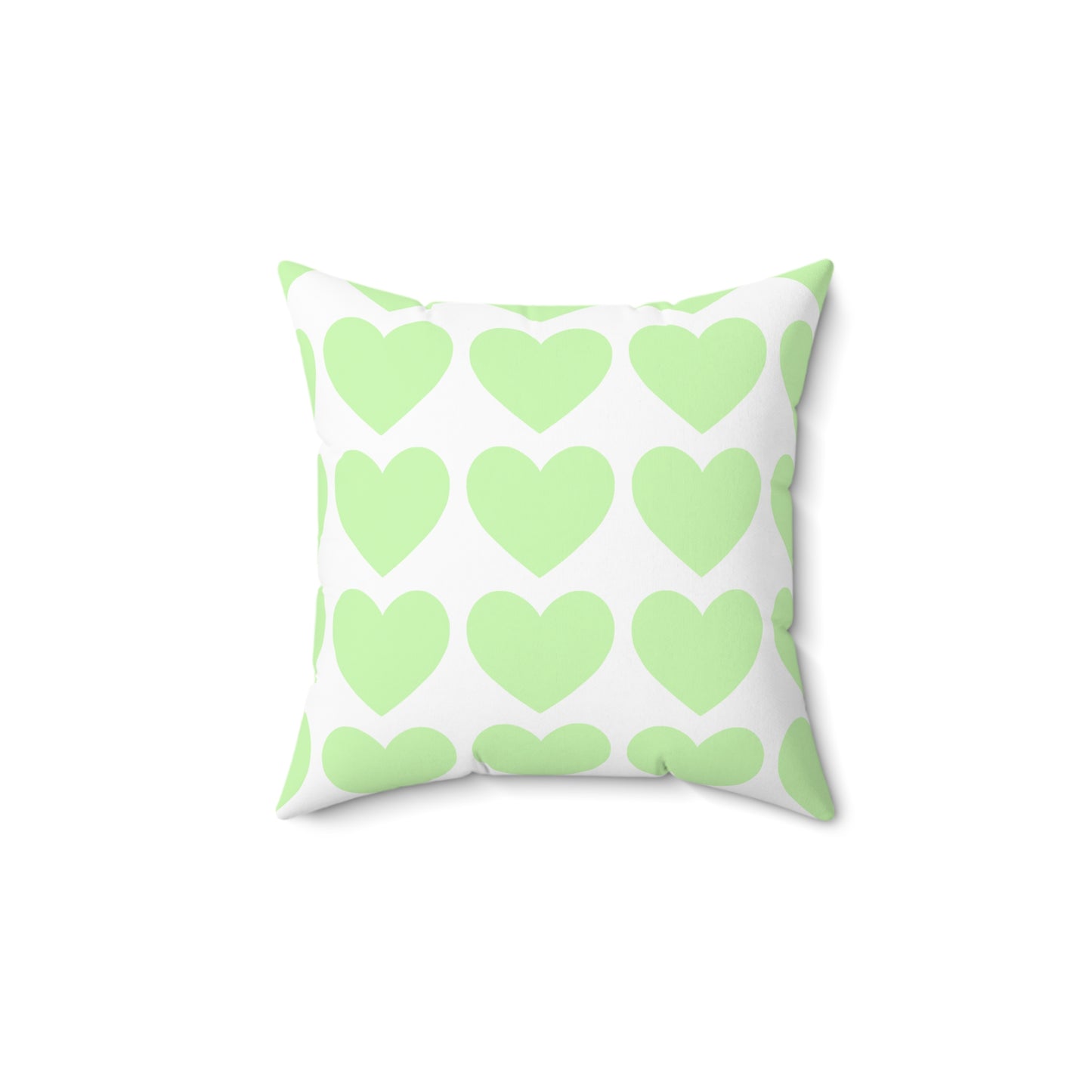 Mint green throw pillow styled on a dorm bed with cozy decor