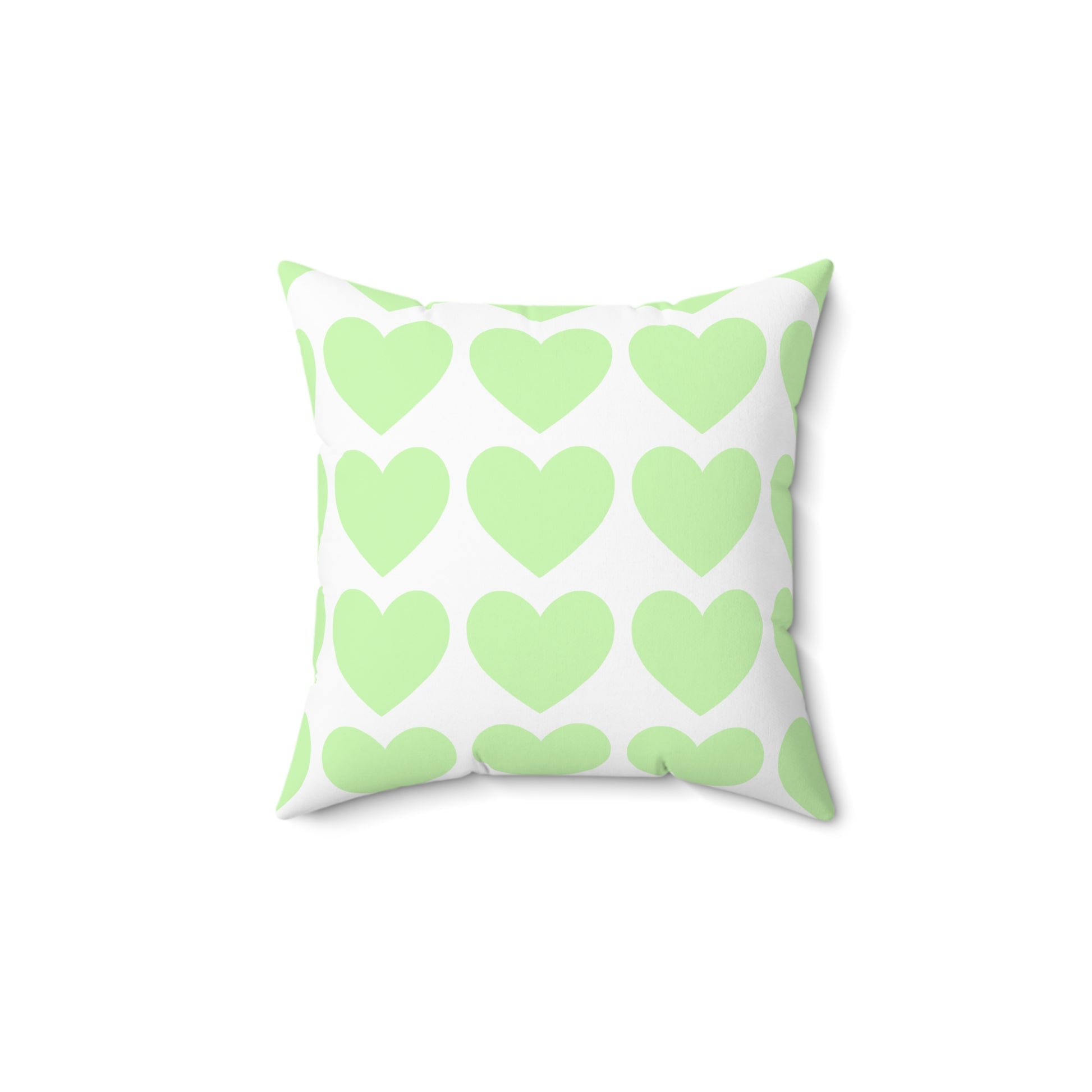 Mint green throw pillow styled on a dorm bed with cozy decor