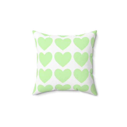 Mint green throw pillow styled on a dorm bed with cozy decor