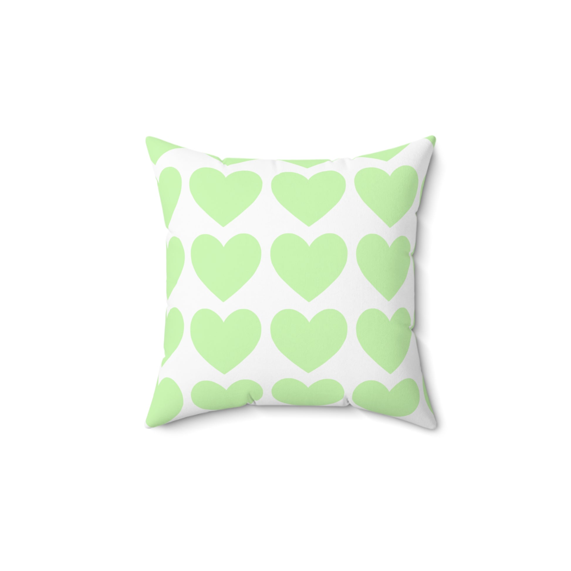 Closeup of soft mint green pillow with whimsical heart accents