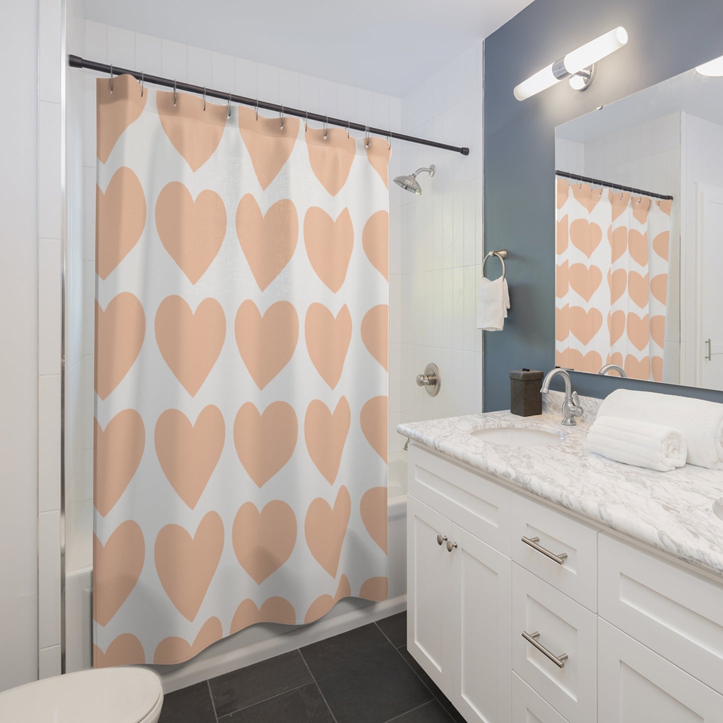 Styled bathroom scene with pastel hearts shower curtain, warm lighting, and Pride-themed accessories